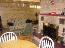 Family room on lower walkout level of Alpine Snow Cabin. Features natural wood burning fireplace.