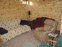 Family room on lower walkout level of Alpine Snow Cabin. Features queen size futon sofa sleeper, leather rocker recliner, love seat, TV with VCR and DVD player. Directv Satellite.