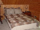 Guest bedroom on second level of Alpine Snow Cabin. Bedroom has view of the golf course.